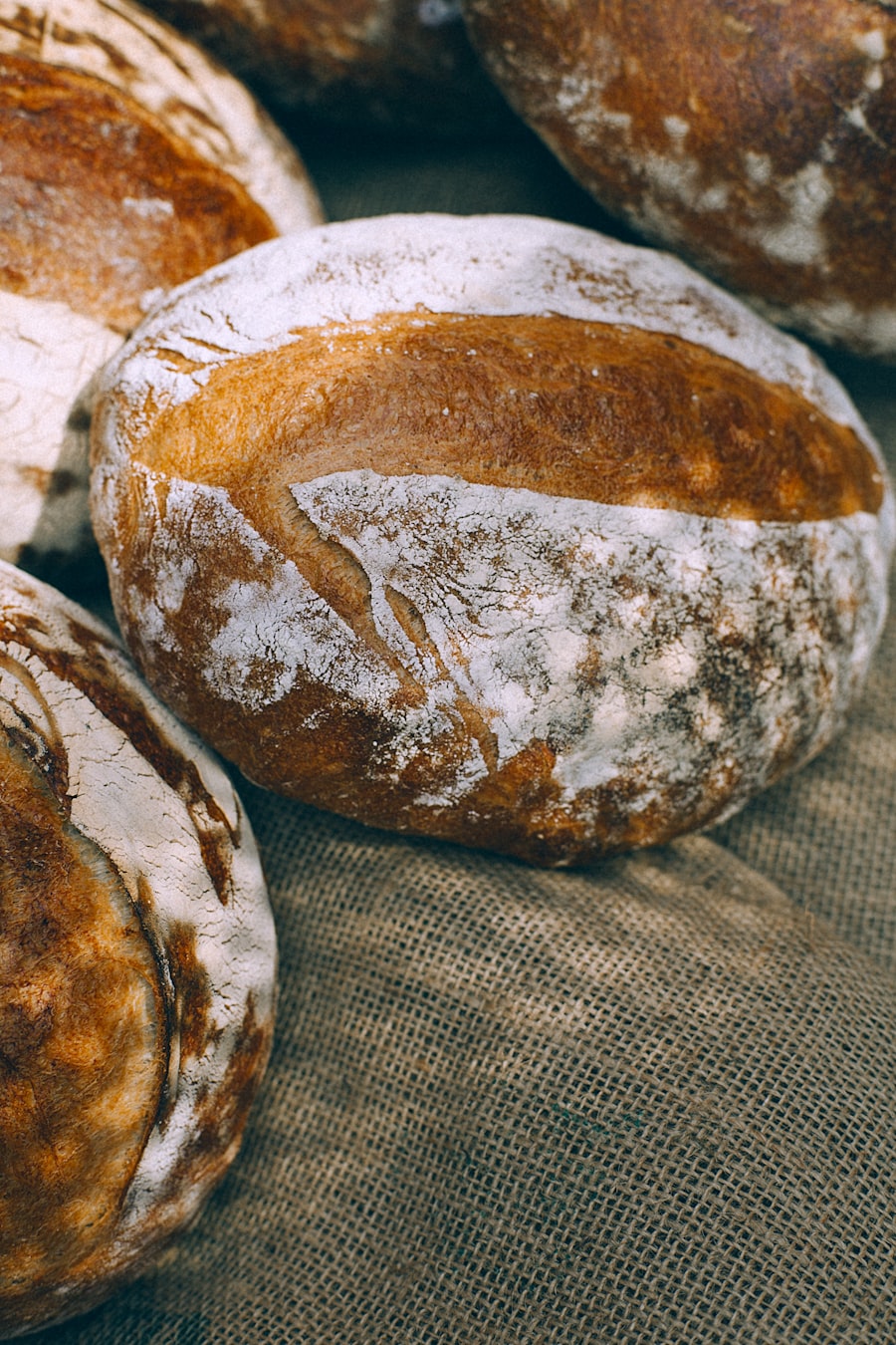 Floured sourdough loaves resting on jute