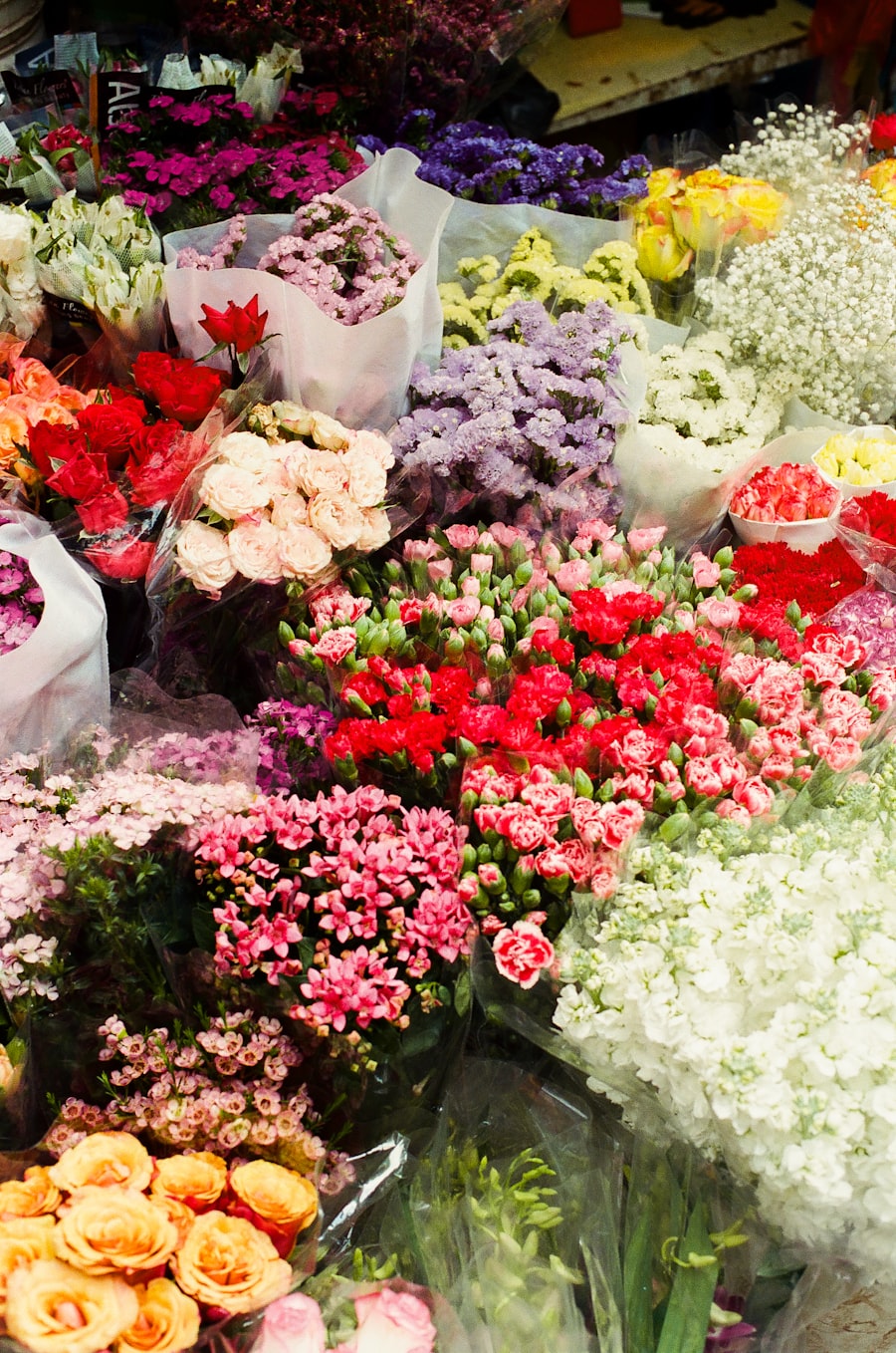 Wrapped bouquets crowding a flower stall